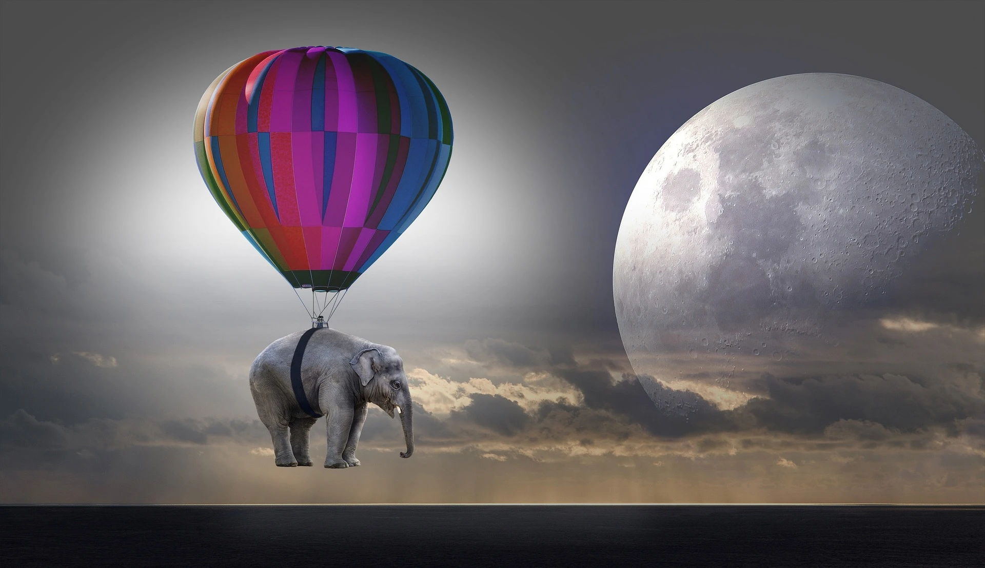 image of an elephant suspended in air from hot-air balloon, the moon in hazy sky visible