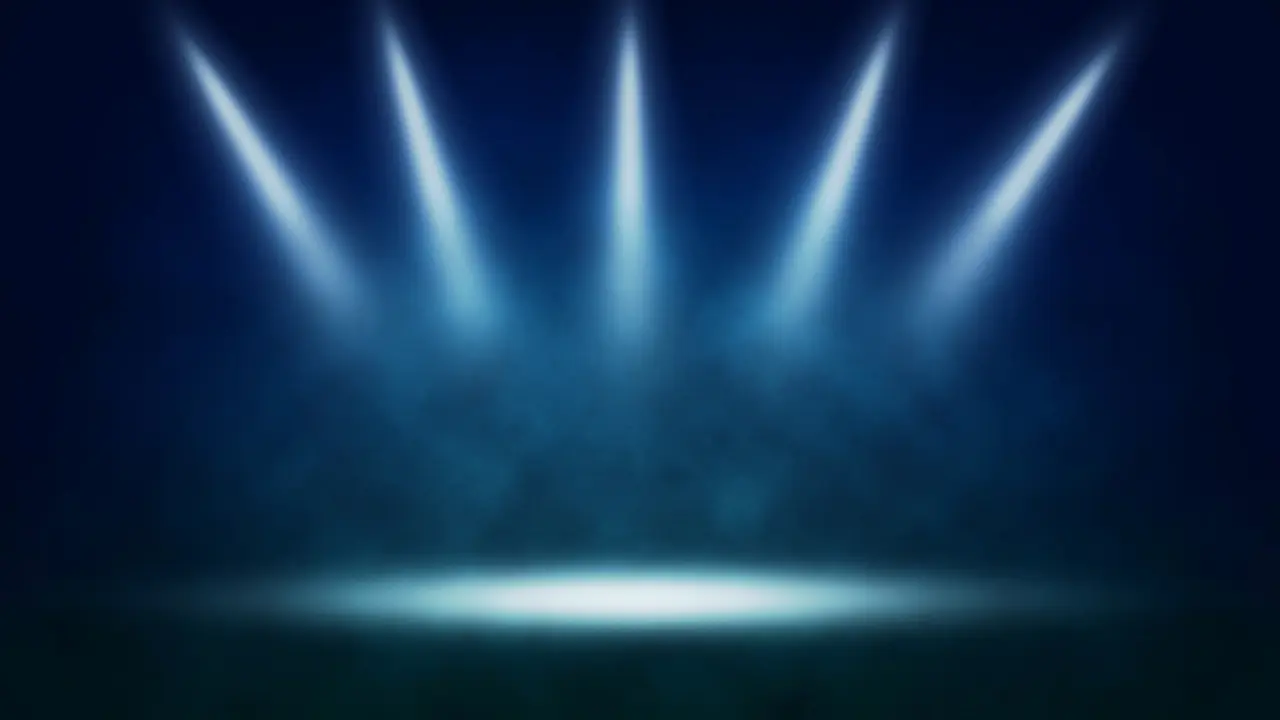 Image of a stage highlighted by several stage lights creating a circle of light with dark blue background